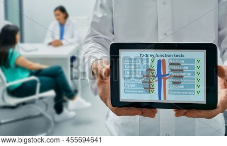 Kidney Function Tests, Concept. Urologist Holding Tablet With Results Of Kidney Function Test, On Ba