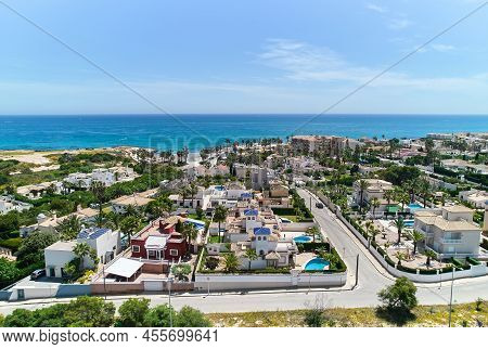 Aerial Panoramic Shot, Drone Point Of View Playa Flamenca Townscape Coastline And Turquoise Waters O