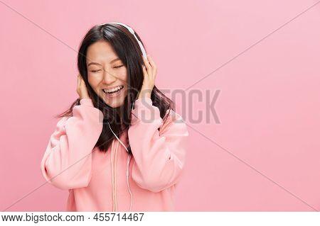 Relaxing Asian Young Lady In Pink Hoodie Sweatshirt With Cute Headphones Listen Fav Song Closing Eye