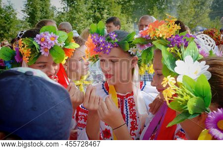 July 18, 2022 - Altai Krai, Russia. Peasant Girls In Ukrainian Folk Clothes And Wreaths Sit On The H