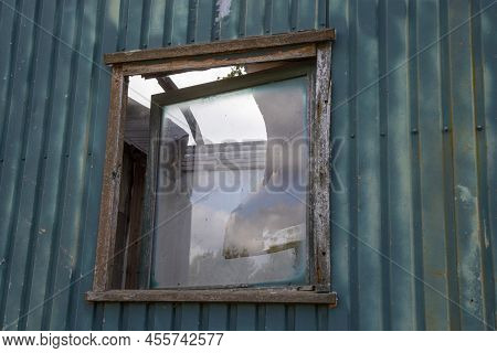 Broken Window On An Old Construction Trailer, Roof Of The Trailer Is Broken As Well