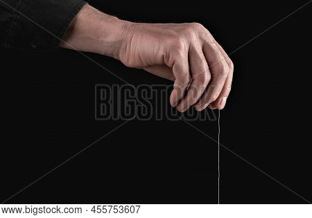Man Hand Holding String For Manipulation, Exploit, Control. Abuse And Toxic Relationship. Manipulato
