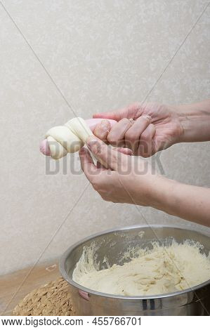 Womens Hands Are Kneading The Dough In The Home Kitchen Near The Wall On The Wooden Structure Table 