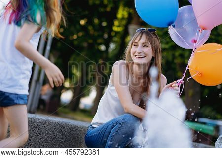 Mother And Daughter Having Fun On Girl Birthday Splashing Near City Fountain