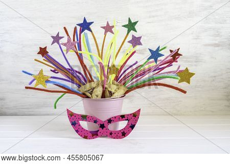 Decoration For Jewish Holiday Purim On White Wooden Background.