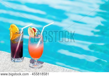Two Cocktails At Swimming Pool In Luxurious Hotel At Sunny Summer Day. Mocktail Drinks With Straws A