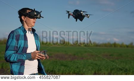 Agriculture. Man Farmer A Aerial Pilot Drone Survey Explorers Green Wheat Crops In The Field. Agricu