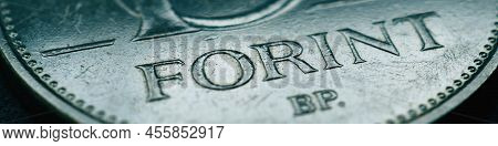 Hungarian Coin Of 10 Forints Lies On A Dark Surface Closeup. Money Of Hungary. News About