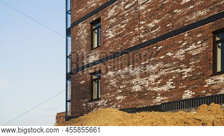 A New Brick House Stained With White Efflorescence, A Crystalline Of Salt, Formed Due To Water Being