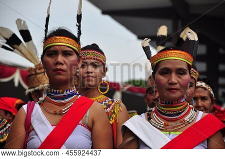 Jakarta, Indonesia - April 28, 2013 : An Old Woman From The Dayak Tribe Of Kalimantan Wears A Red An
