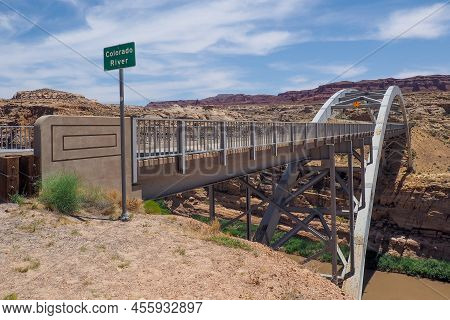 Hite Crossing Steel Bridge Across Canyon Of Colorado River In Utah, Usa. Classic Arch Of A Bridge In