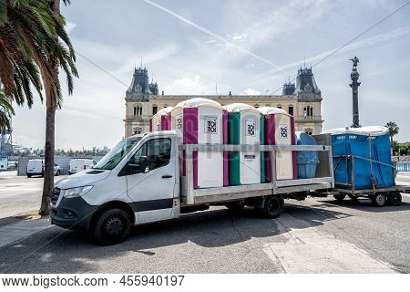 Barcelona, Spain - June 2022: Truck Transporting Portable Plastic Toilets With The Toi Toi Logo For 
