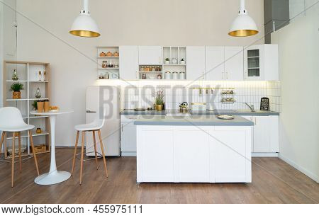 White Kitchen With Counter Table, Bar Dining Table And Accesoires On Shelves