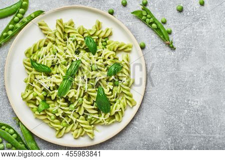 Rotini Pasta With Fresh Green Peas Sauce And Basil Served On Plate.