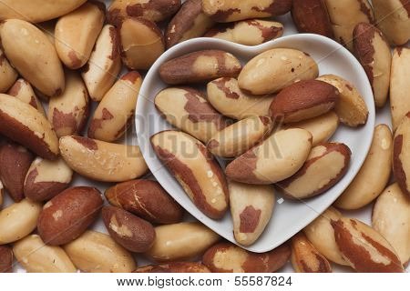 Brazil nut, healthy food ingredient in heart shaped tray
