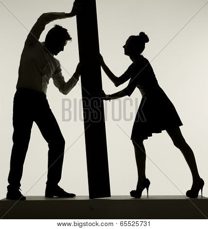 Young couple silhouette holding board