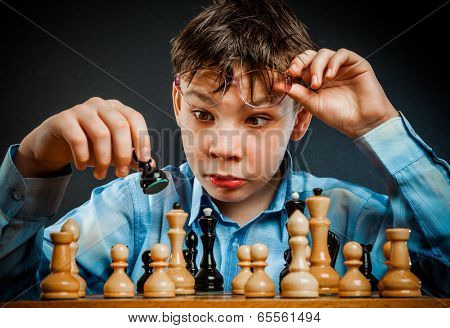 Wunderkind play chess. Funny Nerd boy.