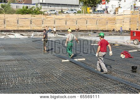 Workers Do The Steel Bars Construction At The Building Site