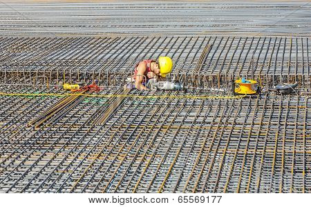 Workers Do The Steel Bars Construction At The Building Site
