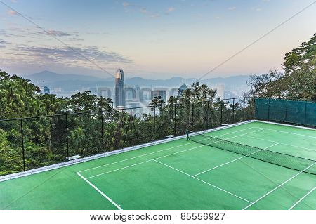 Top Of Skyscraper By Night With Panorama Of Hong Kong And Tennic Courts
