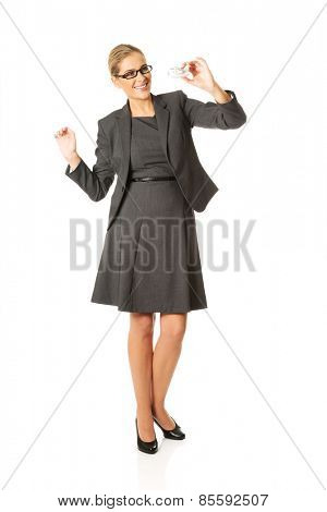 Beautiful businesswoman with plane toy in hand