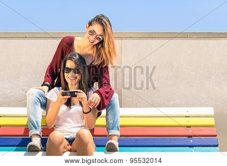 Best Friends Enjoying Time Together Outdoors With Smartphone - Concept Of New Technology