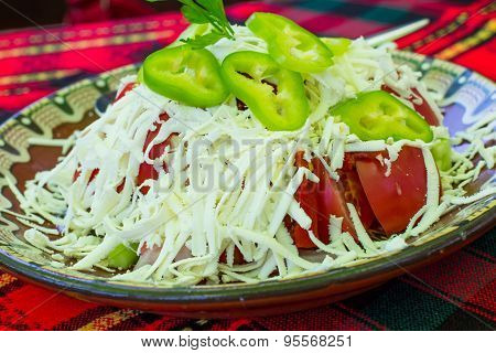 Bulgarian Shopsky Salad made of tomatoes, cucumbers and cheese