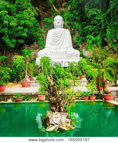 View Of White Buddha Statue And Emerald Pond Among Green Trees