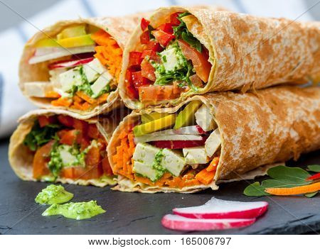 Healthy vegan salad tortilla wraps with tofu and vegetables. Love for a healthy raw food concept.