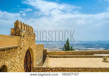 The high ramparts of Kasbah with the scenic hilly landscape on the background El Kef Tunisia.