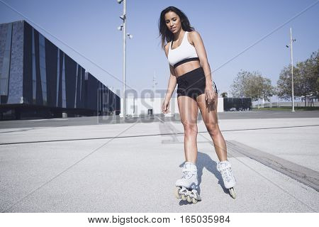 Beautiful girl skating on a sunny day