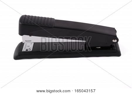 Office stapler for a paper fastening black with metal inserts on a white background white background with soft shadow. Photo with clipping path