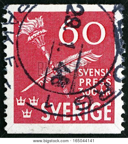 SWEDEN - CIRCA 1945: a stamp printed in Sweden shows Torch and Quill Pen Tercentenary of Swedish Press circa 1945
