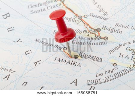 Close up of Kingston Jamaica map with red push pin.
