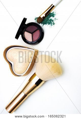 Makeup highlighter, make-up on Valentine's Day, shadow and brushes for make-up, make-up artist for the tools.