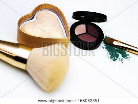 Makeup highlighter, make-up on Valentine's Day, shadow and brushes for make-up, make-up artist for the tools.
