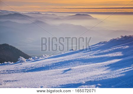 Fantastic evening winter landscape. Dramatic overcast sky.