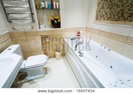 Toilet bowl and sink in a modern bathroom