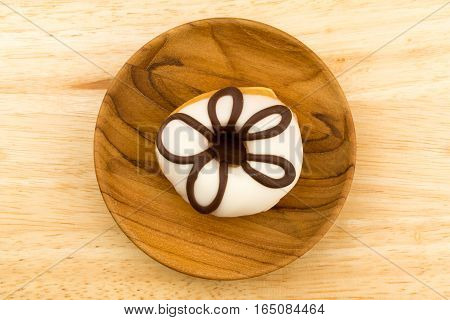 Homemade tasty doughnut in a wooden plate on wooden board