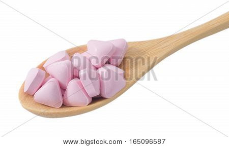 Healthcare Concept Wooden Spoon Full with Vitamins Pills isolated on White Background.