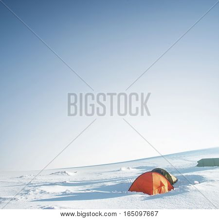 Camp on snow plane in the mountain valley. Active life concept