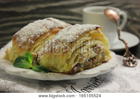 Pastry of airy dough. Warm and delicious snack. Сup and vintage spoon on a wooden table.