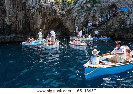 Capri Italy - August 5 2015: Boats with tourists waiting to get into the Blue Grotto