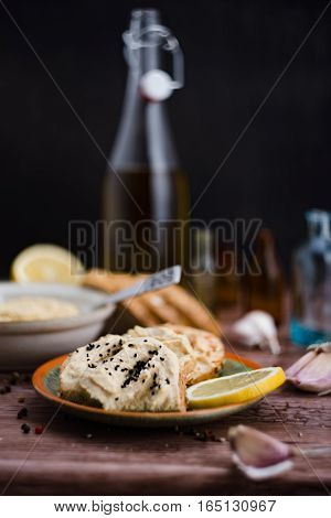 The hummus and ingredients in rustic style.