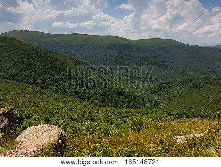 Summertime sunrise in Bieszczady Mountain range with view from Bukowe Berdo and rock in foreground, Bieszczady Ridge, Poland, Europe