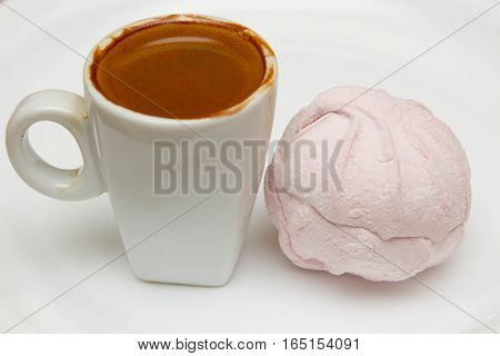 cup of hot espresso and pink marshmallows on a white background, breakfast