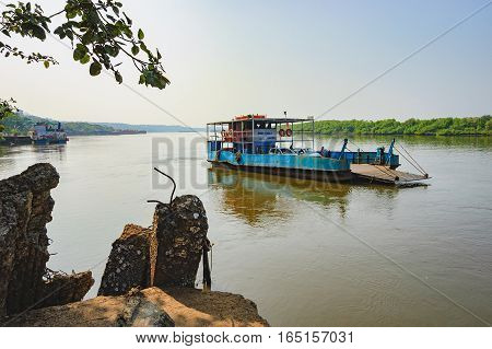 Goa, India - November 13, 2012: Ferry arriving to Chorao island, Salim Ali Bird Sanctuary, Goa, India. Ferries is the only means of transport across the many rivers of India, as there is no bridge.