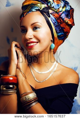 beauty bright african woman with creative make up, shawl on head like cubian  closeup