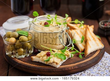 Pate Chicken - Rillette, Toast, Olives And Herbs On A Wooden Board