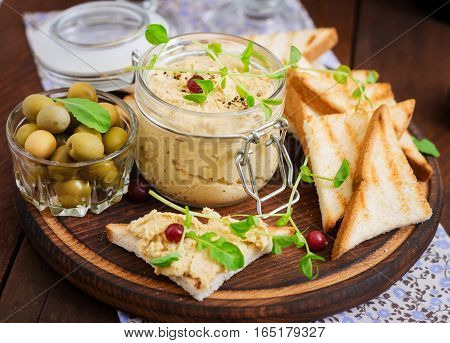 Pate Chicken - Rillette, Toast, Olives And Herbs On A Wooden Board